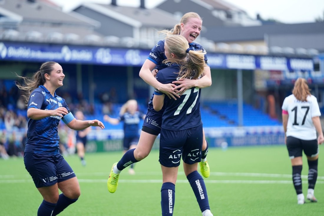 Two KBK players celebrating a goal with a hug